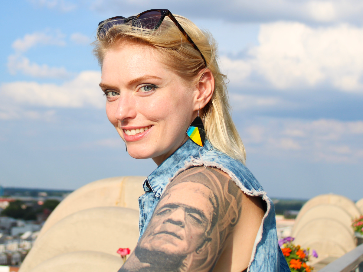 A customer wearing colorful reVinyled earrings