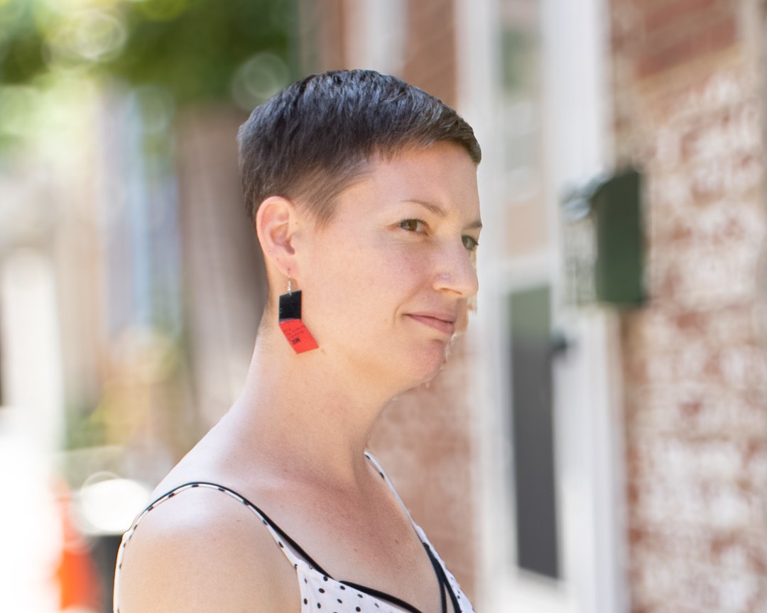 Red reVinyled vinyl record earrings being worn