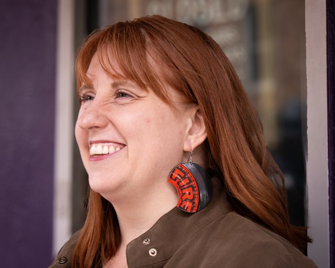 Large red round reVinyled vinyl record earrings being worn