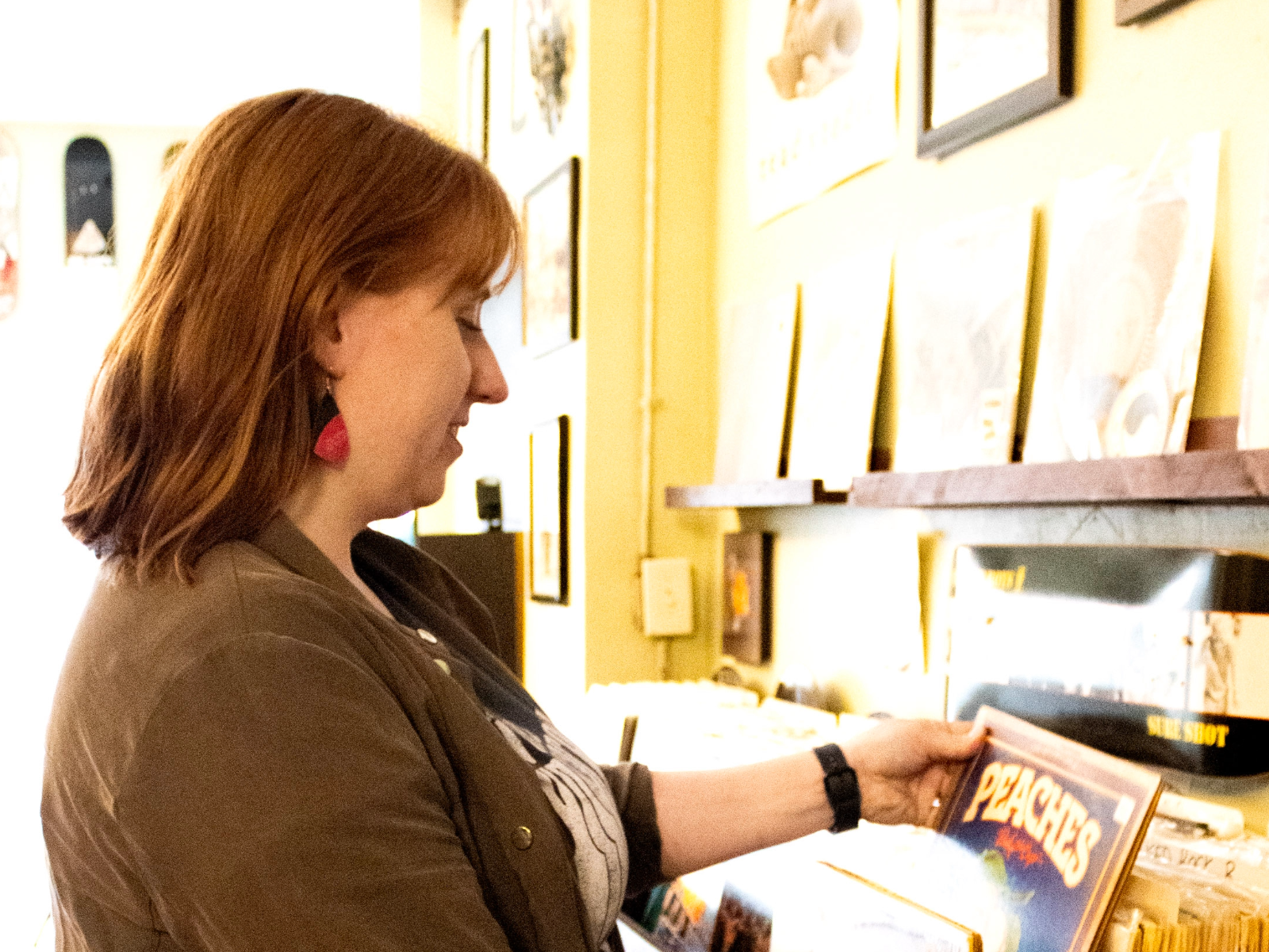 A woman looking through a collection of vinyl records