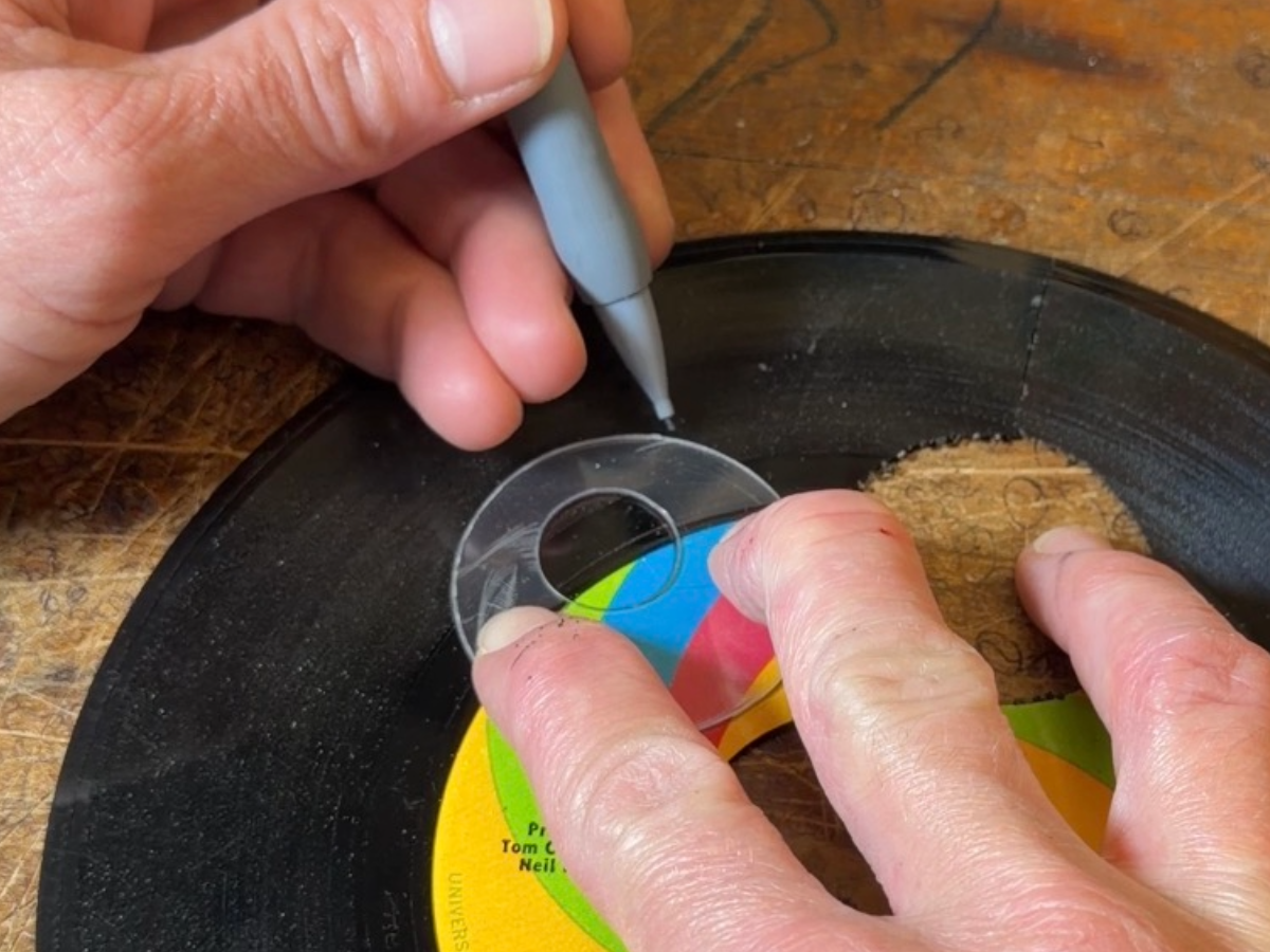 Handmade reVinyled templates arranged over a vinyl record