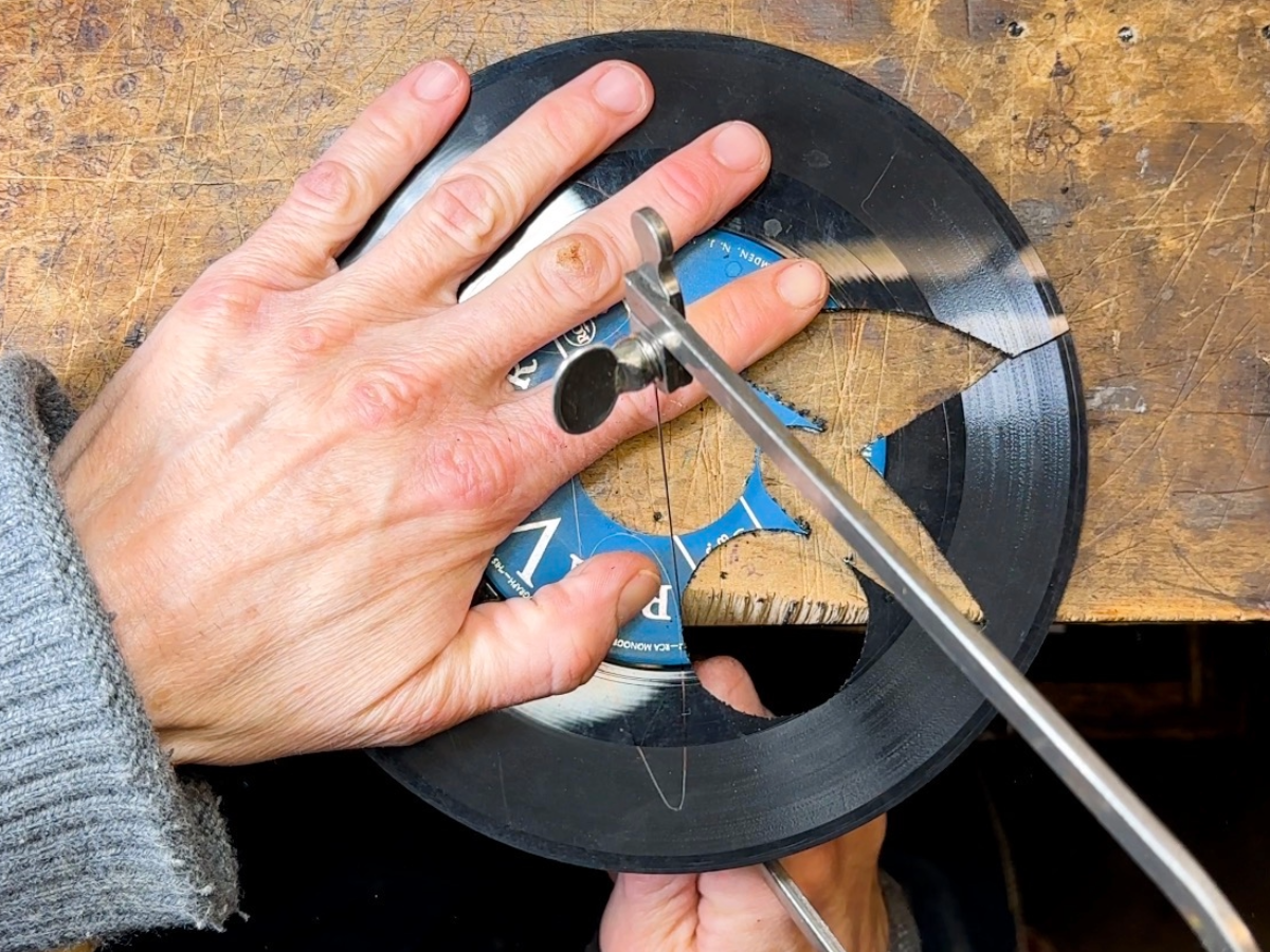 Vinyl being individually cut by hand with a jeweler's saw