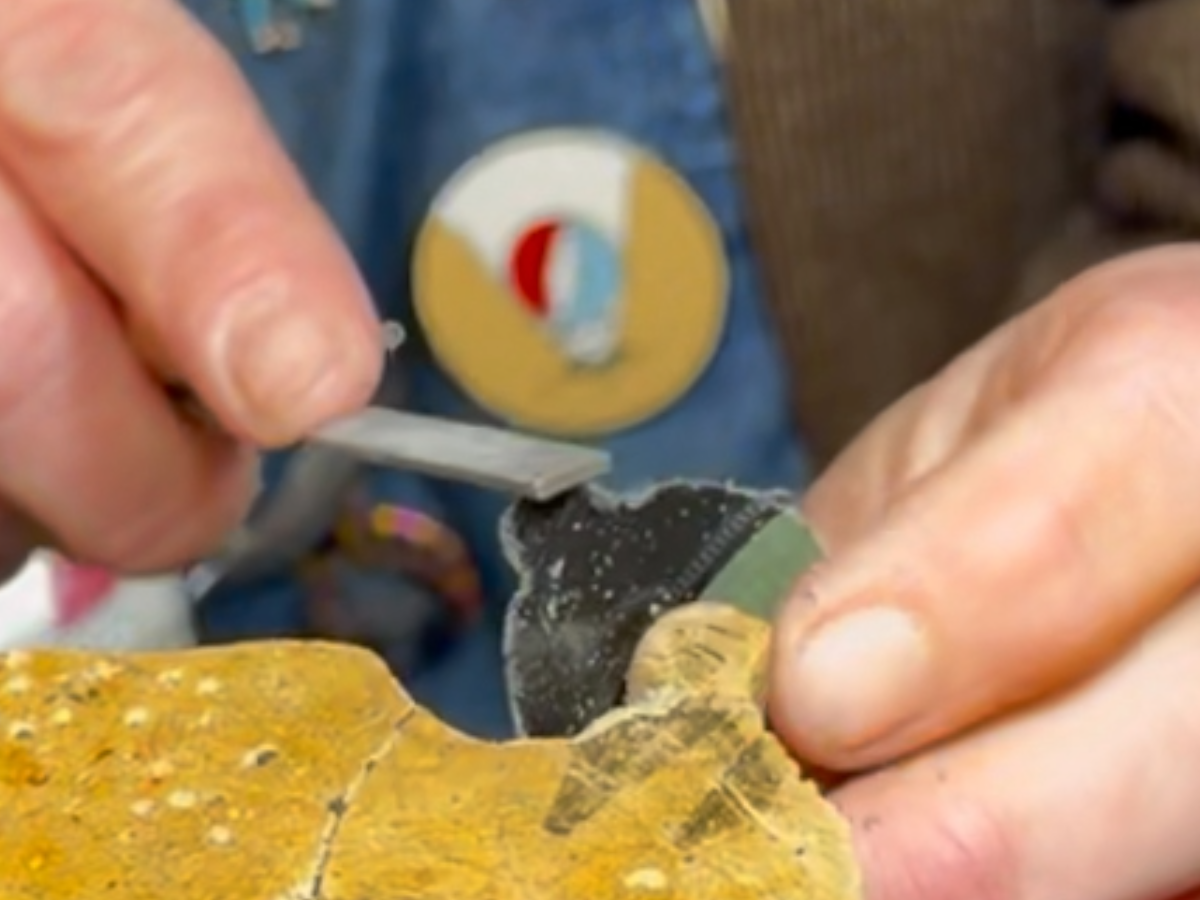 A reVinyled piece being filed and refined by hand