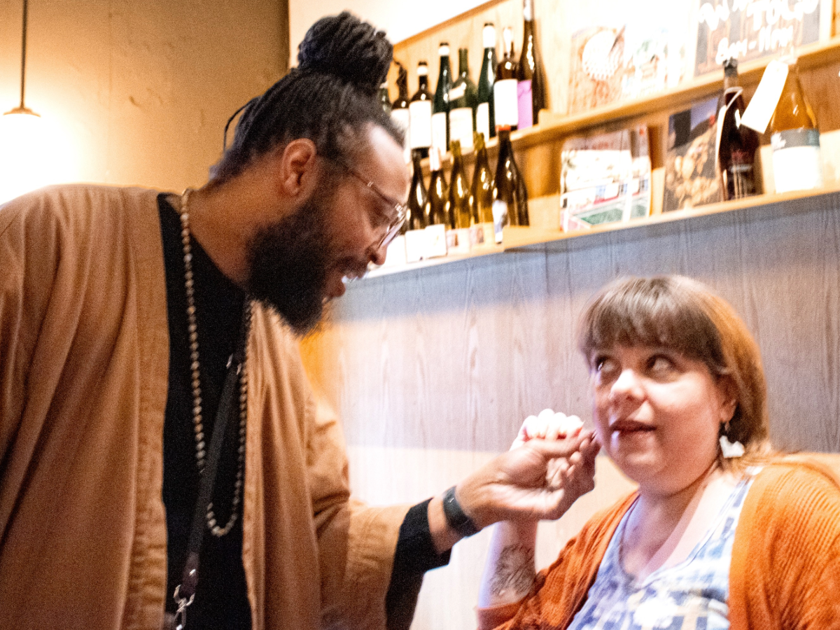 Two people connecting through a reVinyled earring in a shop