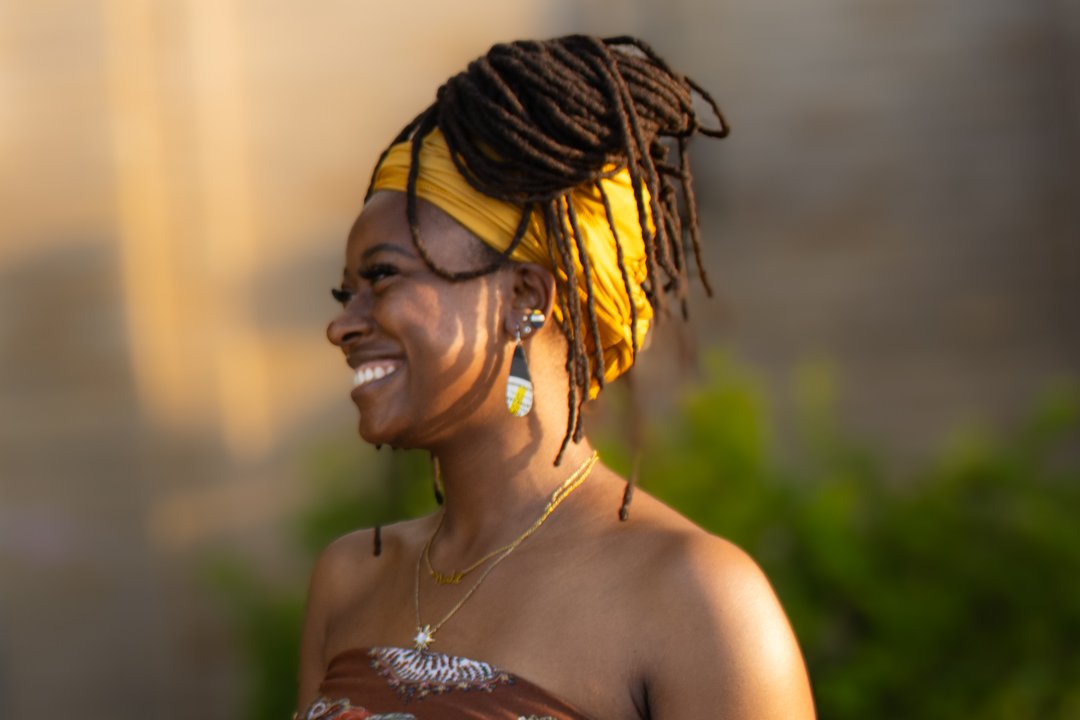 Woman wearing reVinyled earrings handcrafted from the matching vinyl record